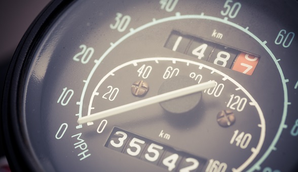 Color horizontal shot of the speedometer of a vintage car.