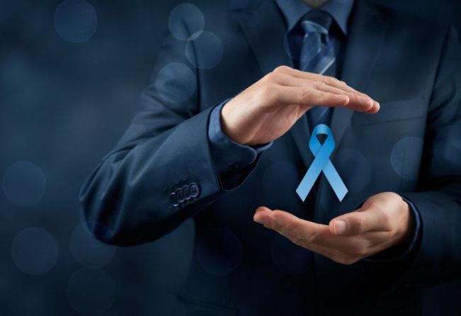 Prostate cancer awareness, peace and genetic disorder awareness - man with protective and support gesture and blue ribbon. Wide banner composition and bokeh in background.